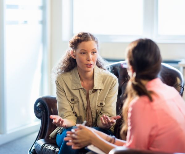 a young person and a health professional meeting