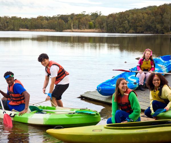 young people kayaking at a canteen program